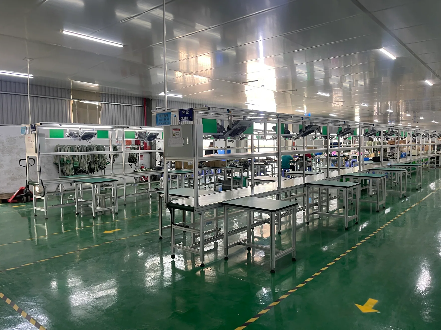 Assembly workstations and cable-handling areas inside the MEIGUAN facility.