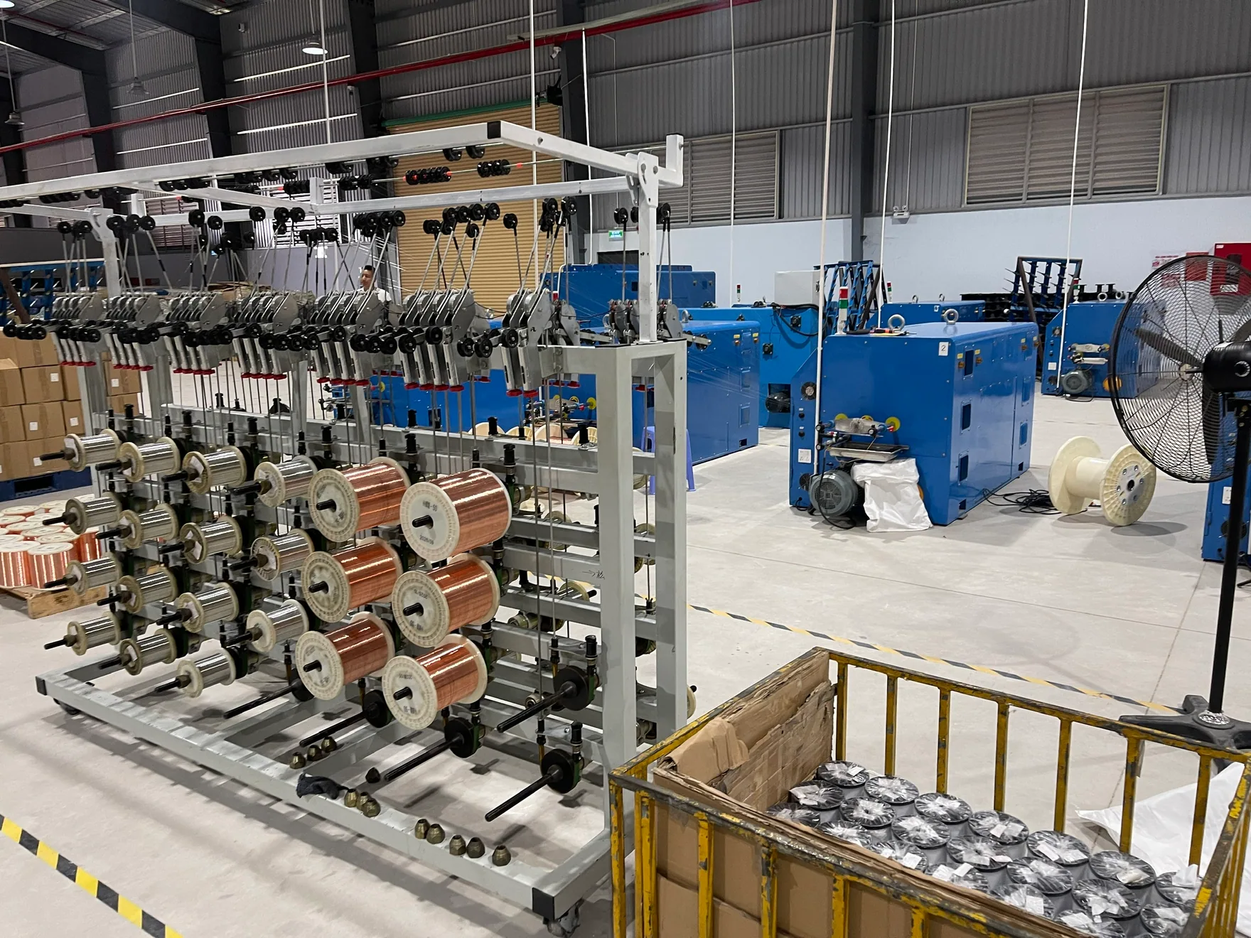 Conductor spools and cable production equipment at the MEIGUAN facility in Vietnam.